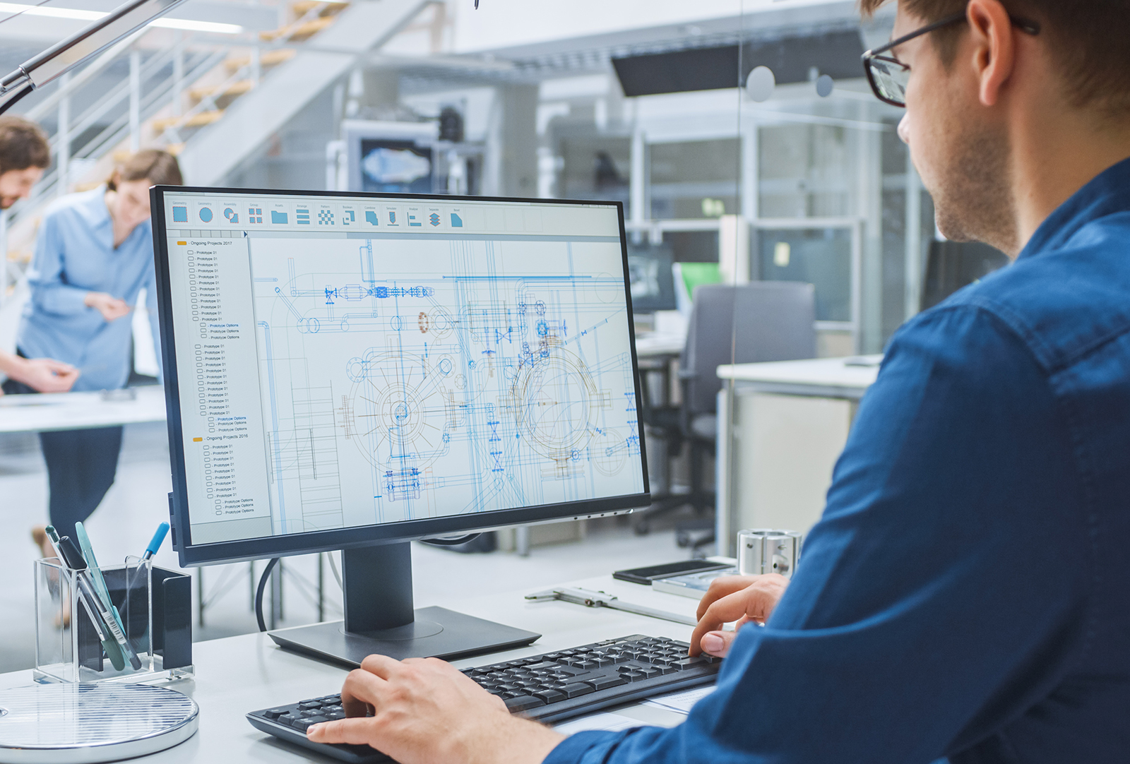 Over the Shoulder Shot of Engineer Working with CAD Software on Technisches Büro & Arbeitsvorbereitung